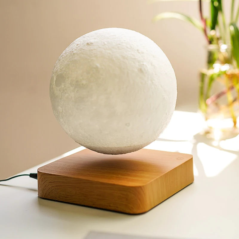 A levitating moon lamp with realistic lunar texture, suspended above a natural wood base. The lamp appears to float mid-air, providing a calming glow and adding an enchanting touch to any room. Perfect as a decorative piece or nightlight.