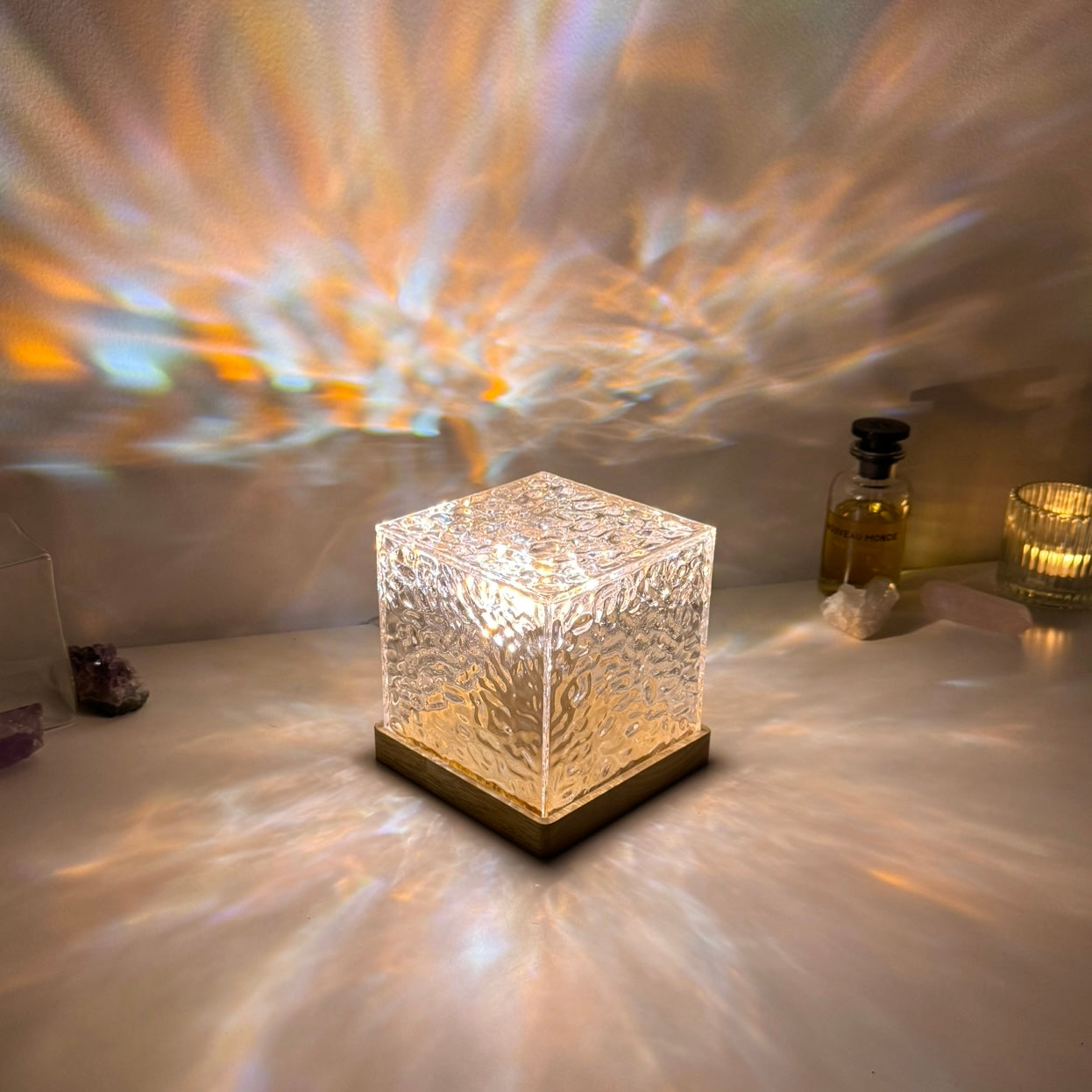 Crystal LED cube lamp with unique textured glass on a wooden base, casting a spectrum of light reflections across the surface. Ideal for enhancing ambient lighting in modern interiors, home offices, or meditation spaces with a calming and aesthetic appeal.