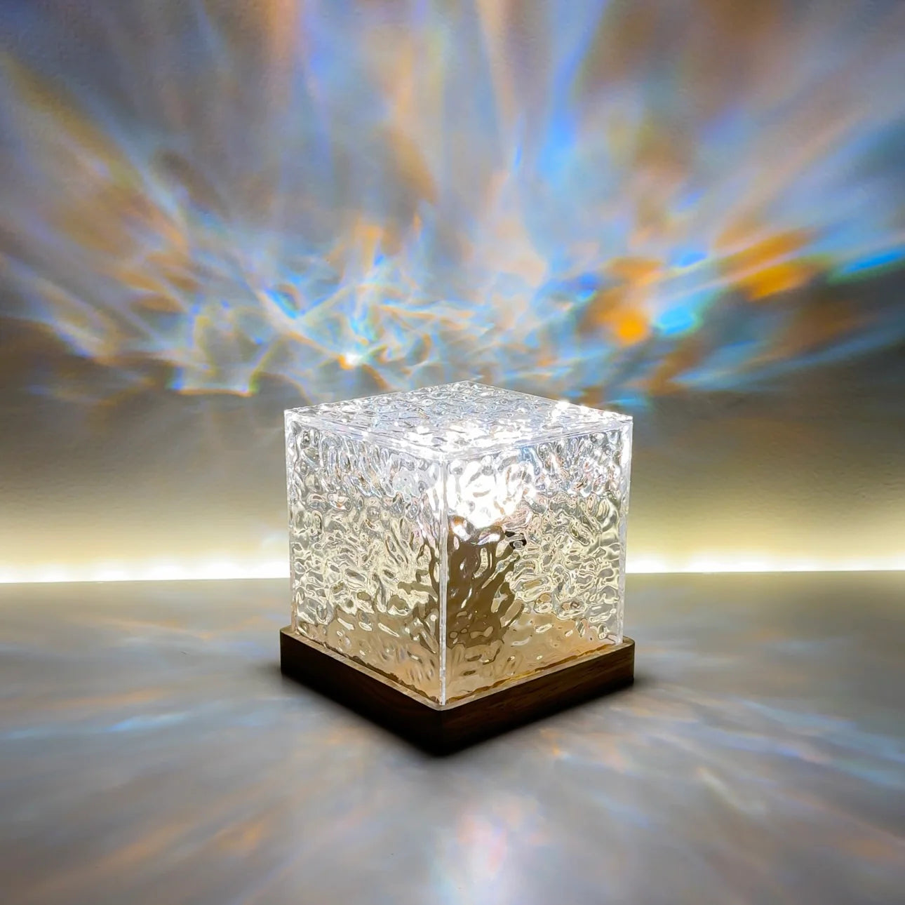 Crystal cube LED lamp on a wooden base, projecting colorful light patterns across the wall. Perfect for adding a modern, ambient glow to any room, this decorative light enhances relaxation spaces, living rooms, and bedrooms.