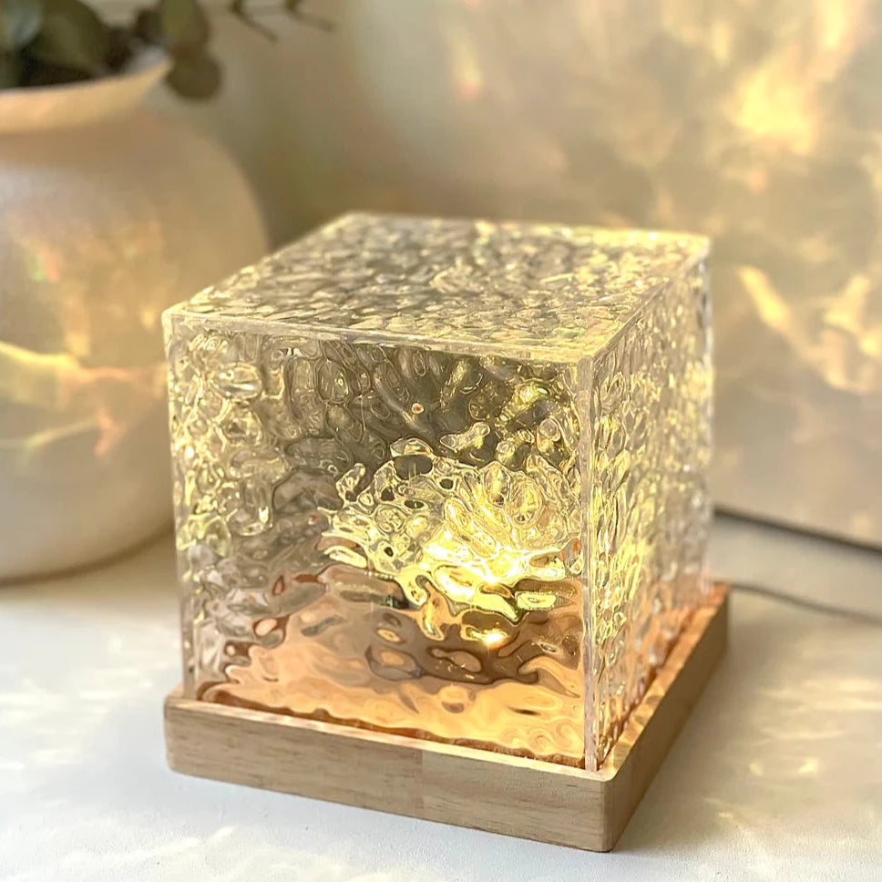 Elegant LED cube lamp with textured glass and wooden base, emitting a soft golden glow. Ideal for modern home decor, this ambient light adds a warm, relaxing atmosphere to any room. Perfect for bedside tables, living rooms, and cozy spaces.