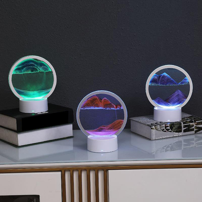 Three LED sand art lamps showcasing vibrant, shifting sand landscapes in green, red, and blue tones. Each lamp features a circular design, creating serene mountainous scenes illuminated by soft, ambient LED light. Ideal for adding a touch of modern decor and relaxation to any space.