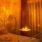 Warm and cozy bedroom illuminated by a soft amber glass sphere lamp on a side table, casting soothing light patterns across the room. The setting features a vintage-inspired bed with a flower-shaped pillow, a unique arched floor lamp, and elegant curtains, creating a serene and inviting ambiance ideal for relaxation and unwinding.